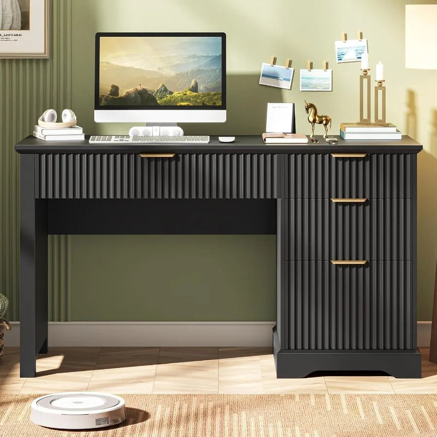 Front view of the black four-drawer desk styled with a desktop computer and stationery.