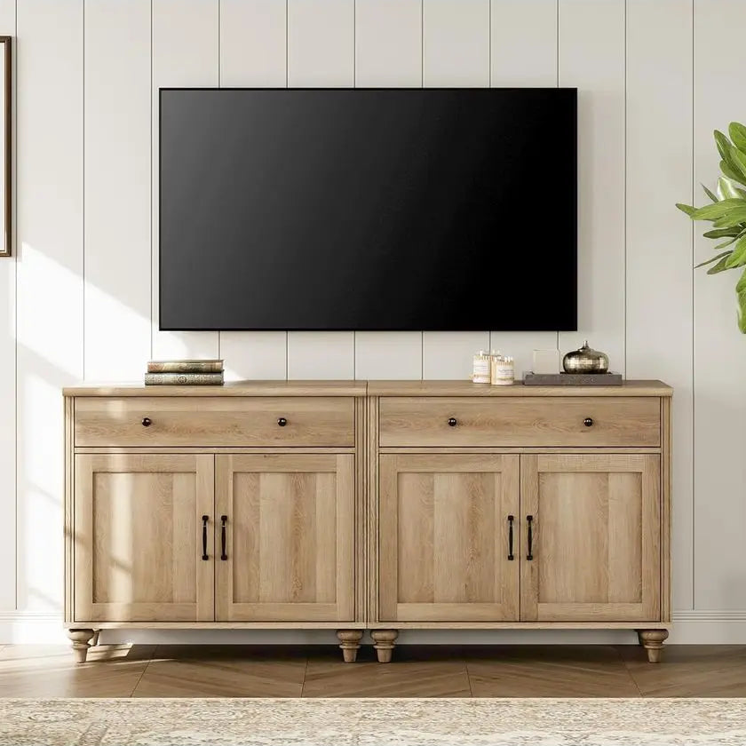 Wooden TV stand with a television mounted on a wall in a room with a plant and framed picture.