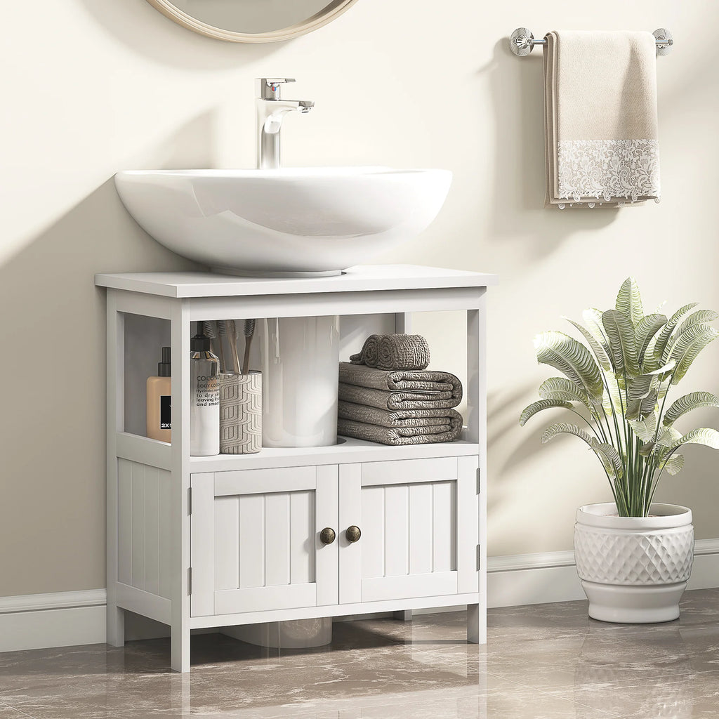 White Kleankin cabinet fitted around a pedestal sink in a bathroom with towels and toiletries on the open shelf