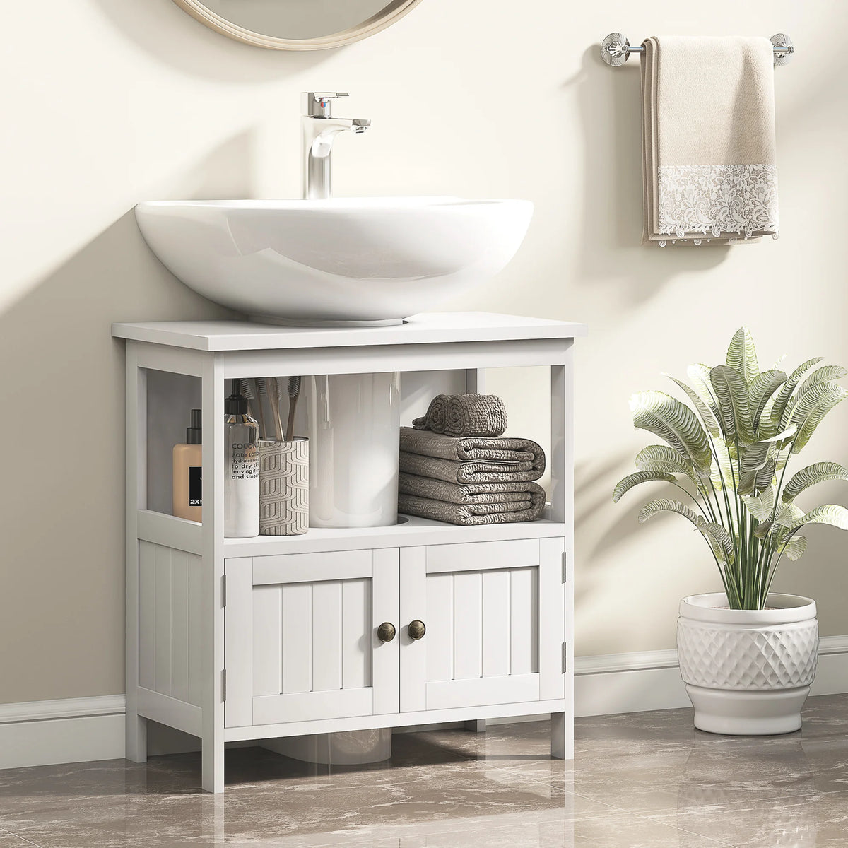 White Kleankin cabinet fitted around a pedestal sink in a bathroom with towels and toiletries on the open shelf