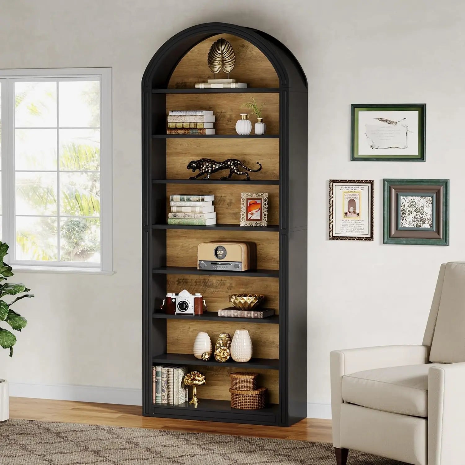 Arched bookshelf in a room with decor items and a chair.