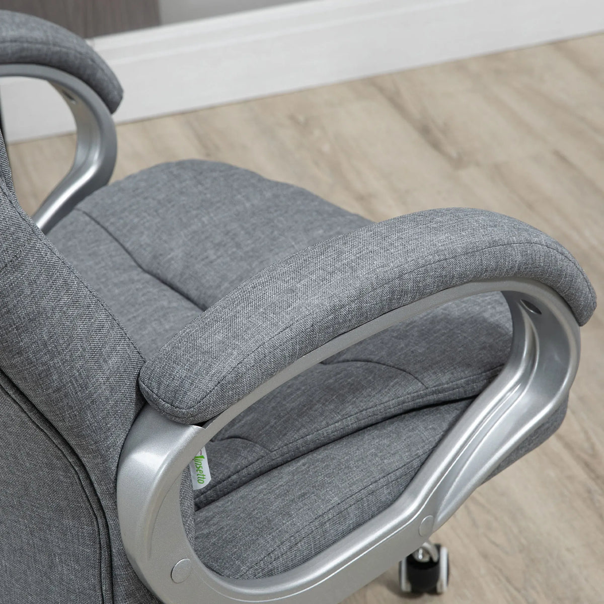 Close-up of the gray woven upholstery, padded armrest and curved silver-toned arm support.