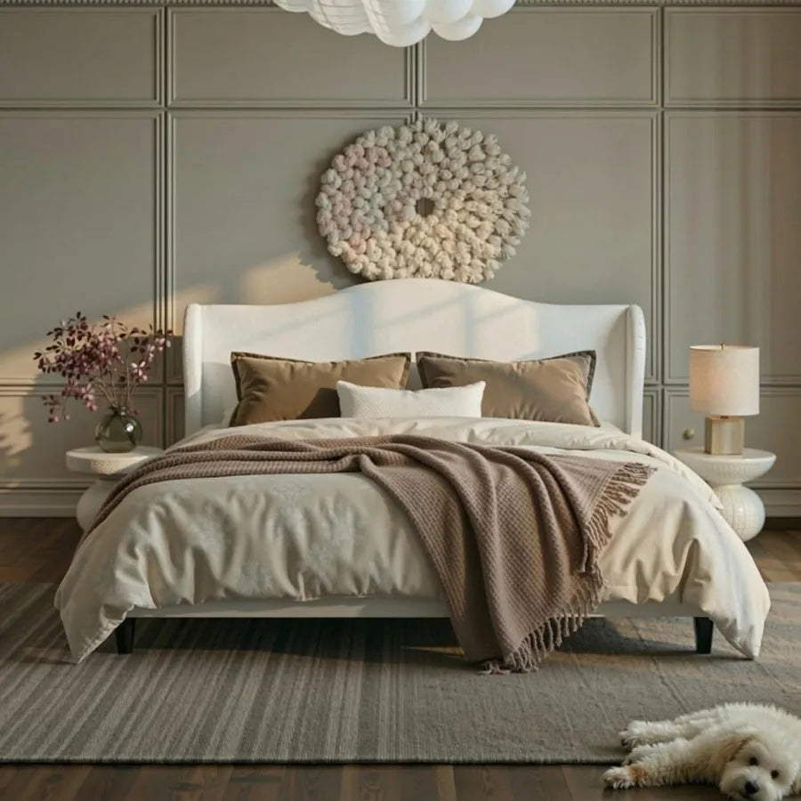 Cream-toned upholstered bed styled against a paneled wall with coordinated bedding.