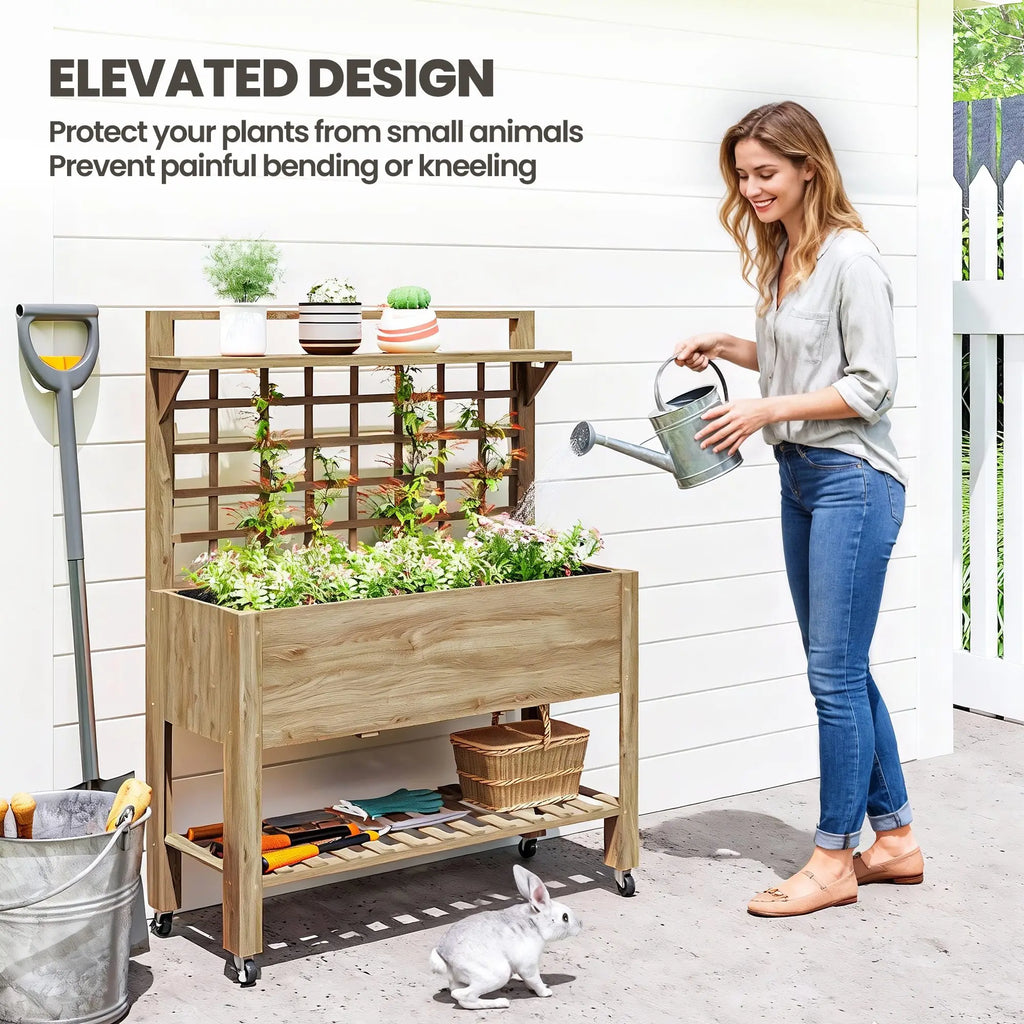 Briarwheel elevated planting station shown being watered beside a garden wall