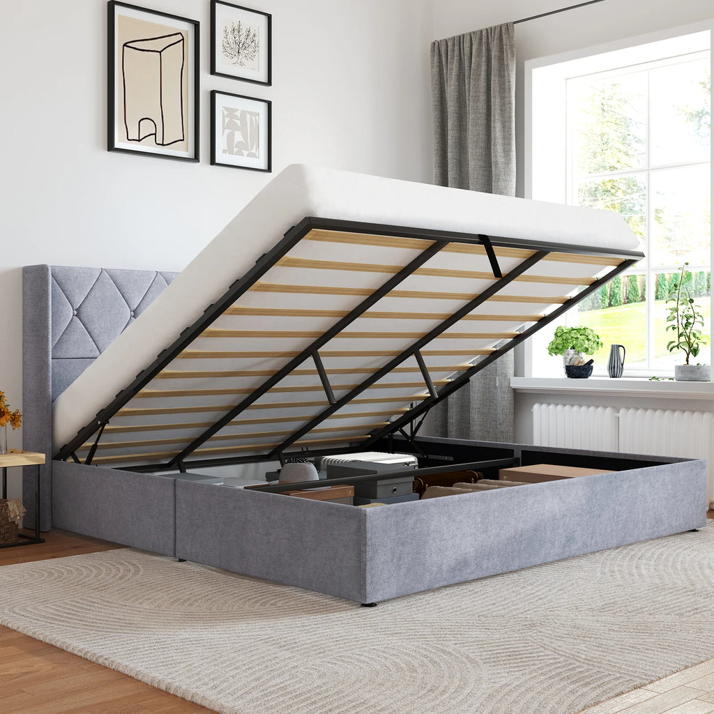 Gray upholstered bed with storage compartments in a room with a window and decor.