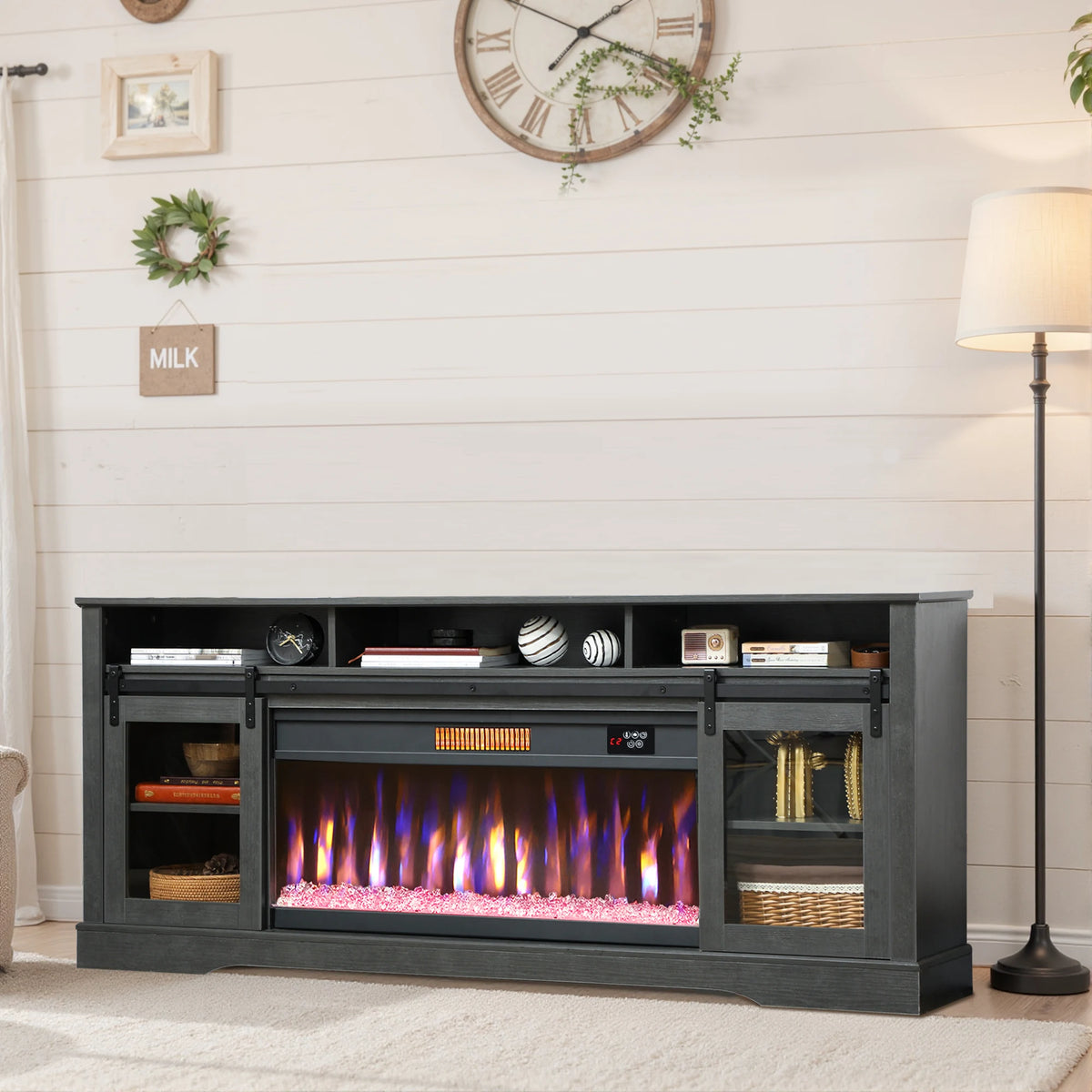 Threadveil dark gray fireplace TV stand with purple and orange flame effects in a living room.