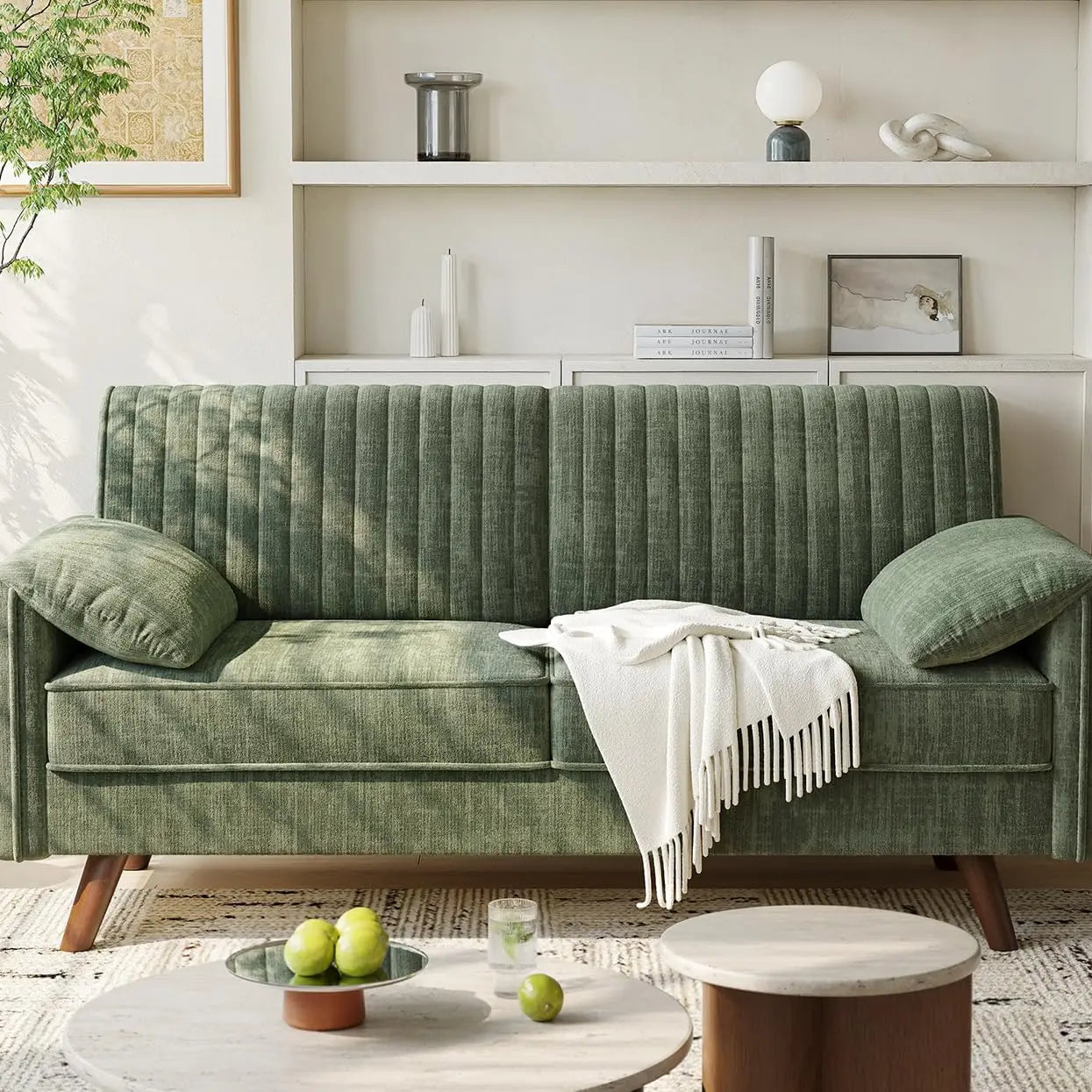 Green sofa in a living room with a coffee table and decorative items.