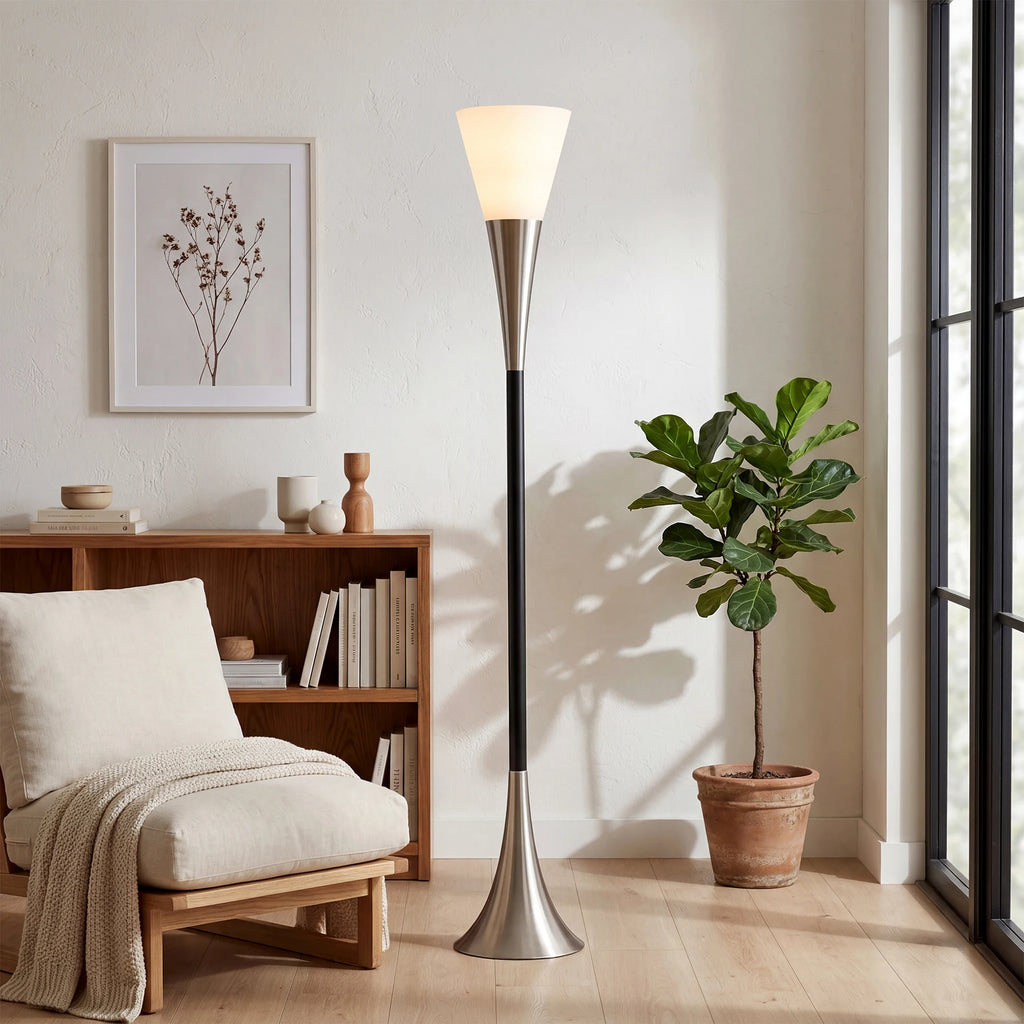 Modern floor lamp in a living room with a plant and bookshelf.
