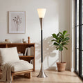 Modern floor lamp in a living room with a plant and bookshelf.