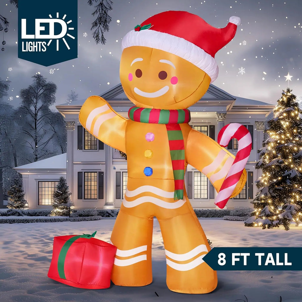 Gingerbelle lighted gingerbread inflatable with a Santa hat, striped scarf, candy cane and red gift detail