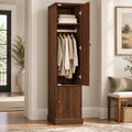 Narrow retro-brown wardrobe with the tall upper door open to show a hanging rod and shelf above a lower fluted door.