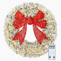 Frostbow snow-flocked Christmas wreath with a dimensional red bow and LED lights