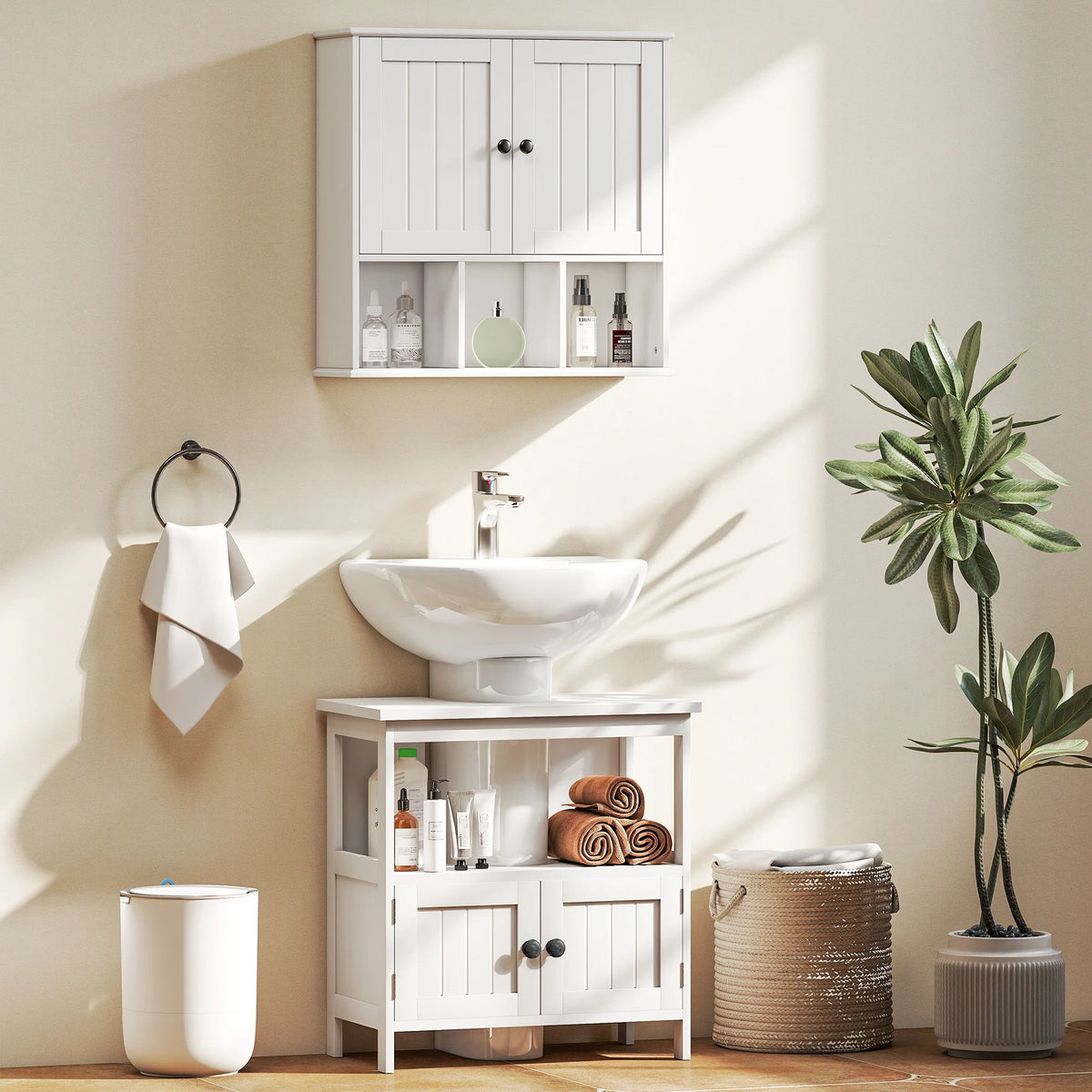 White Kleankin under-sink cabinet in a bathroom scene with a separate wall cabinet and decorative accessories
