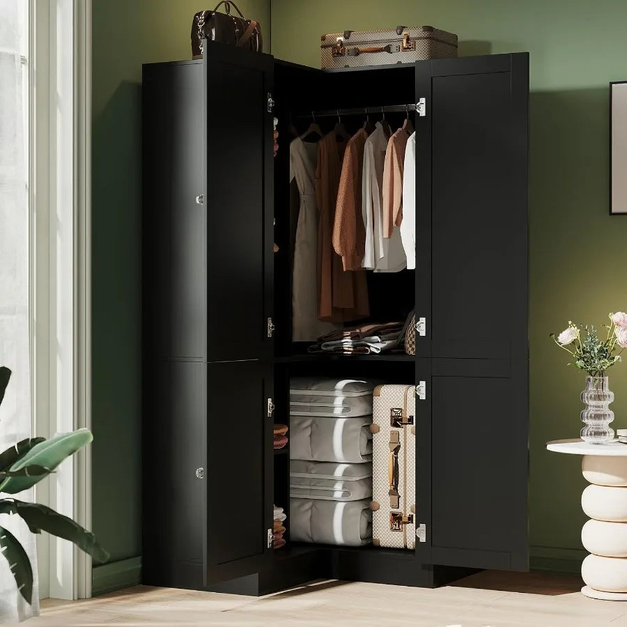 Bedroom corner view of the open black armoire with hanging clothes and lower storage.