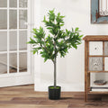 Springwick artificial laurel tree in a black pot beside a glass door and console