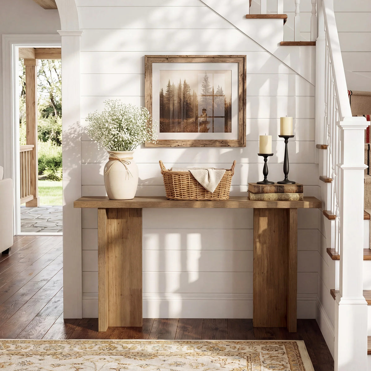 Front view of Harmonysong console table beside a staircase, with broad panel supports and an open base.