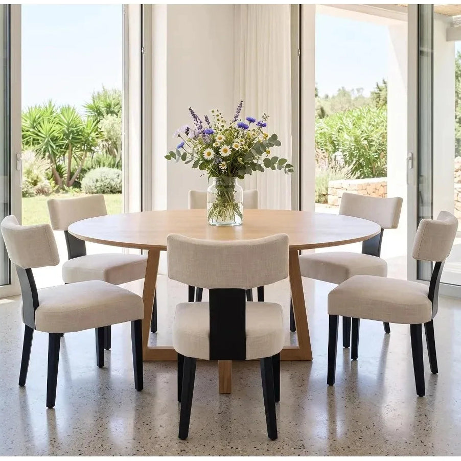 Six Sevrin beige dining chairs with dark legs arranged around a round dining table