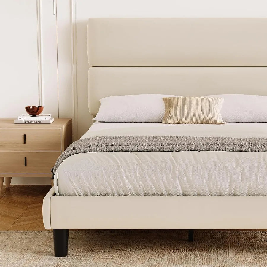 Beige footboard and side-rail detail with staged bedding