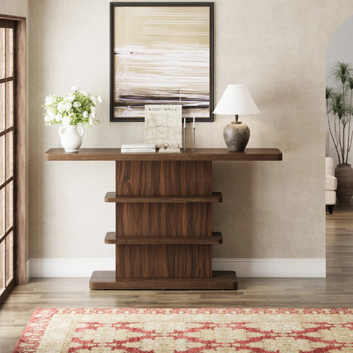 Atterley dark brown console table with two open shelves, styled beneath framed artwork