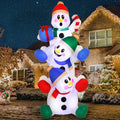 Snowtumble three stacked snowmen with colorful winter accessories, a gift and candy-cane details.