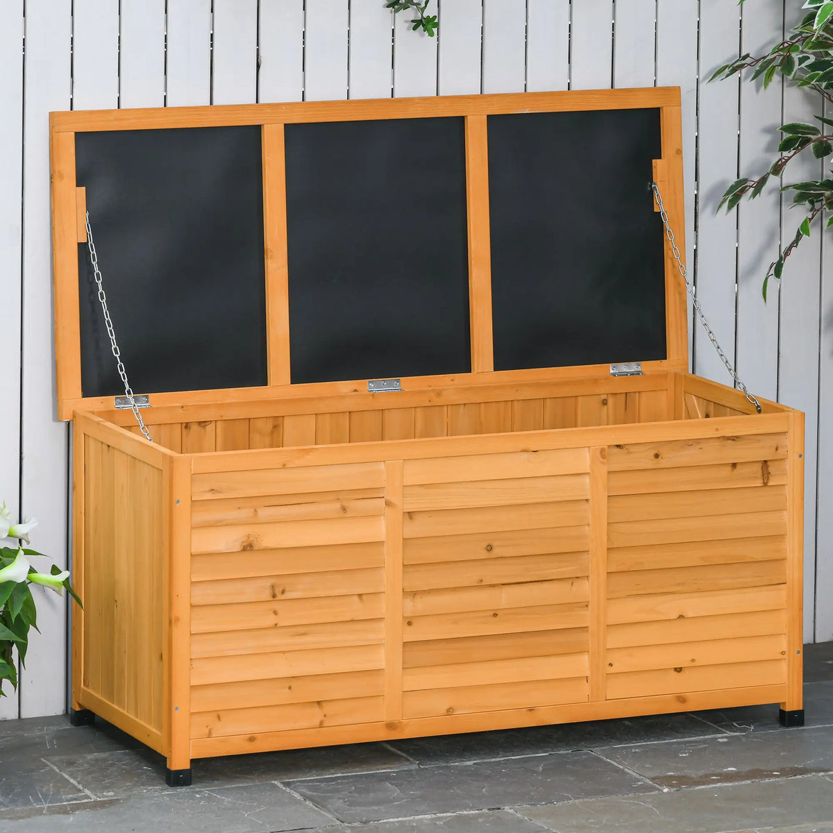Langmere fir wood deck box with hinged lid and support chains on a patio