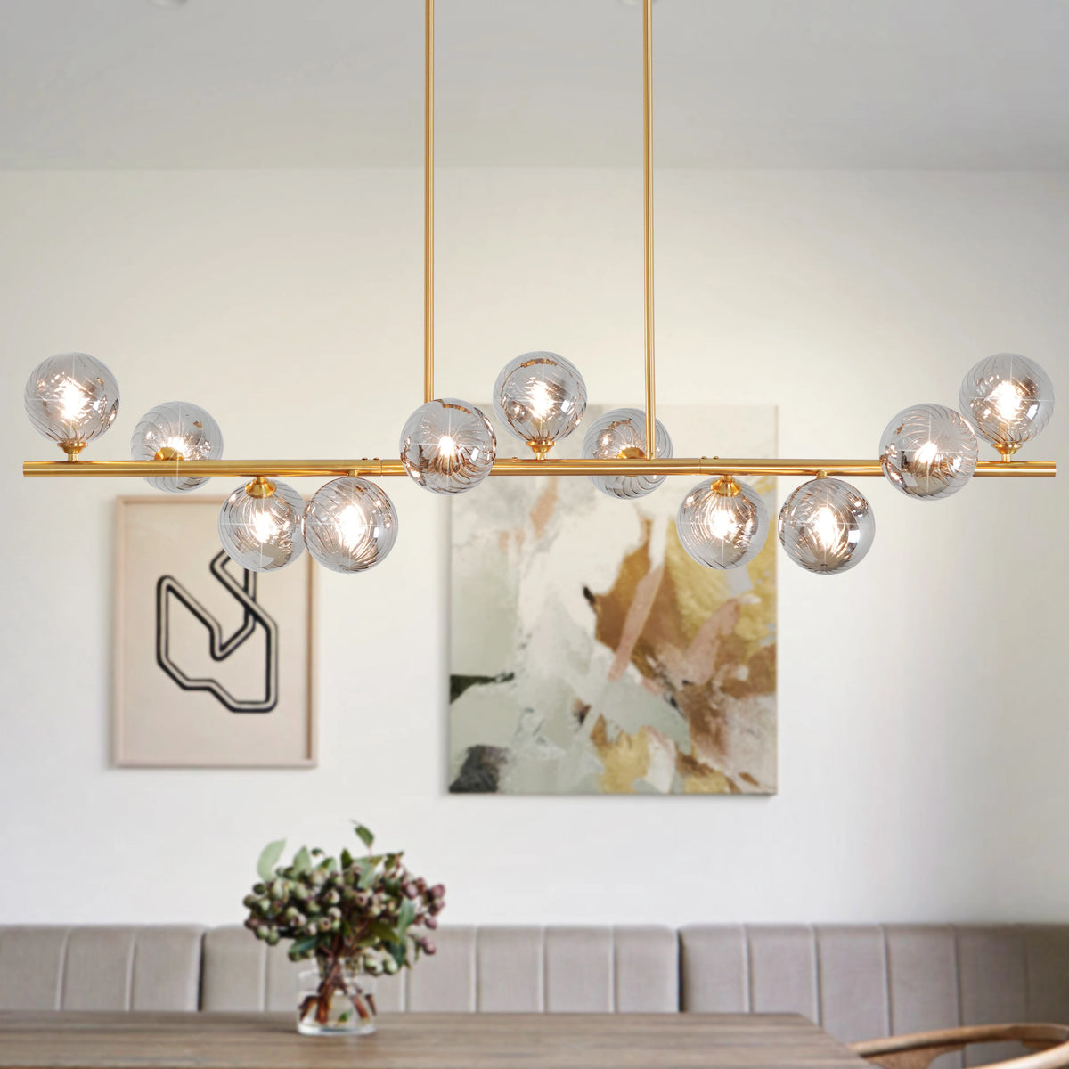 Orbstem linear chandelier with eleven textured glass globes and a gold-tone bar.