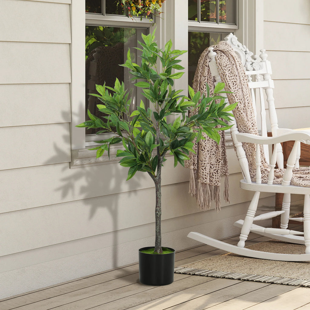 Springwick artificial laurel tree in a black pot beside a rocking chair