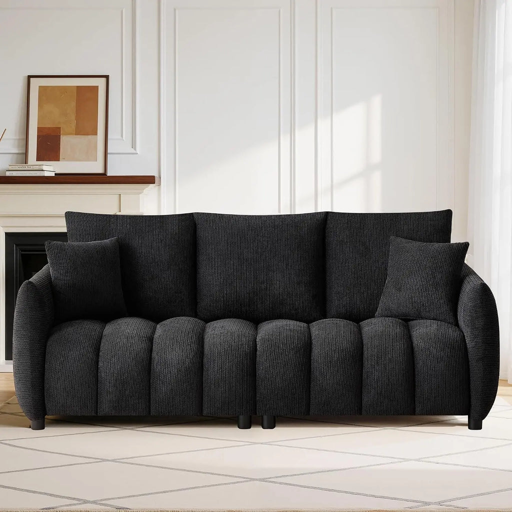 Loftelle Black sofa with textured upholstery, channel-detailed seating and two matching pillows.