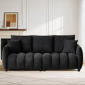 Loftelle Black sofa with textured upholstery, channel-detailed seating and two matching pillows.