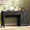 Black fluted desk with gold-tone pulls, a wide center drawer and three right-side drawers.