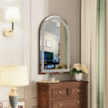 Decorative mirror with a wooden dresser and lamp in a room setting