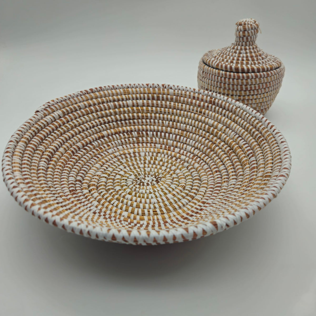 White Senegalese handwoven shallow basket with coordinating lidded basket